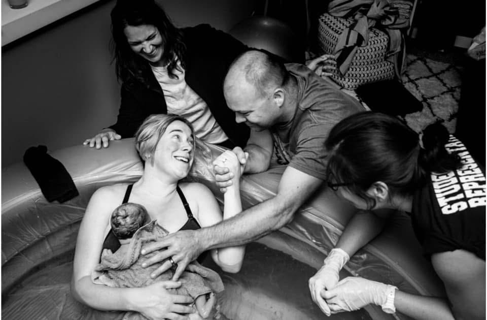 A joyful family moment with a newborn baby.