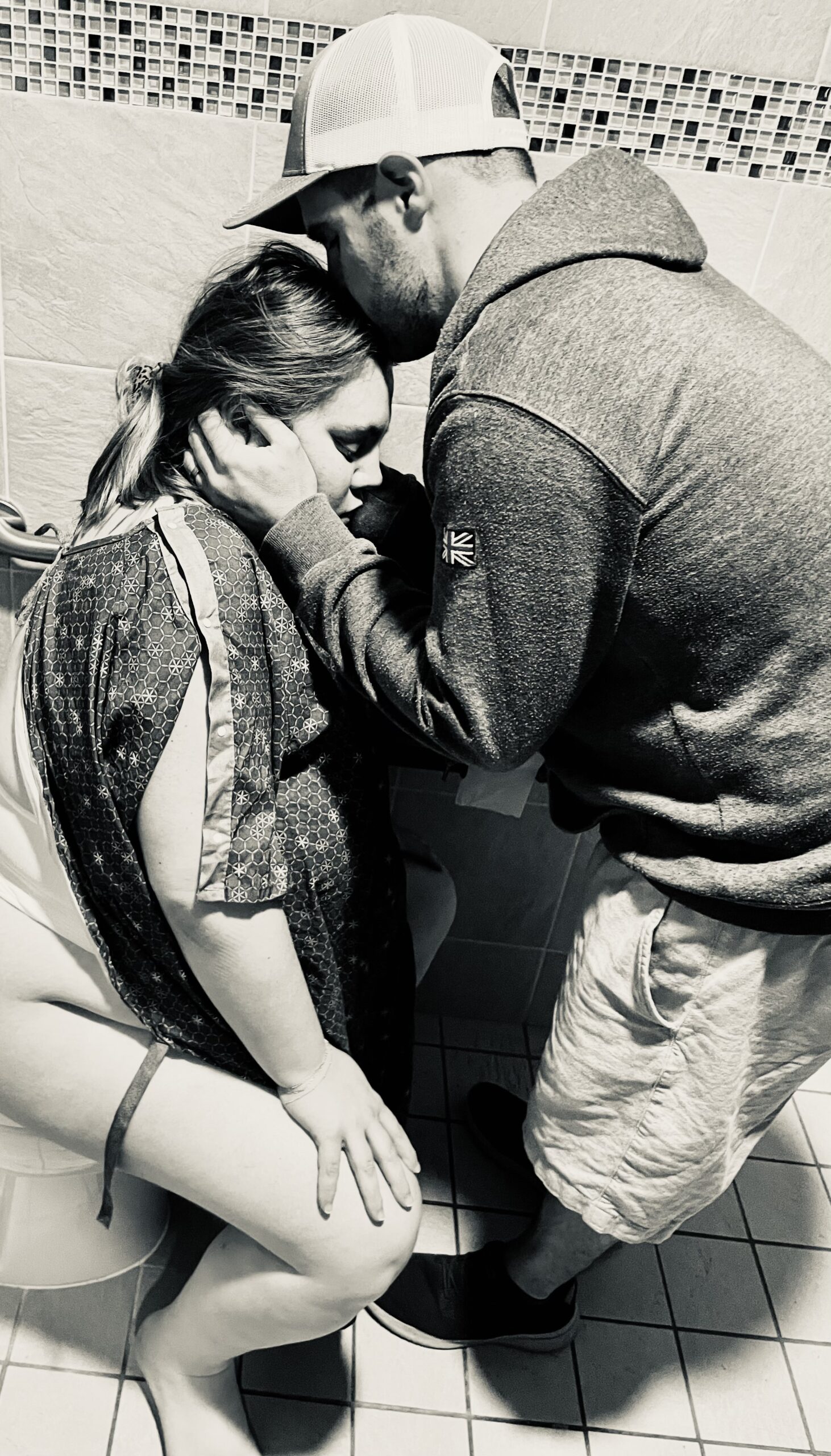 A man gently holds a woman's face in a tender moment.