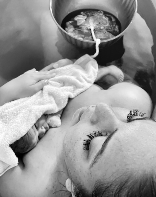 A newborn baby resting on a mother's chest after birth.